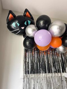 a bunch of balloons that are in the shape of cats and kittens with faces on them