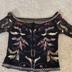 Intricately Beaded Top With Gold Burgundy And Iridescent Beads Atop A Fine Black Mesh Overlayed Upon A Black Sweetheart Neckline Bustier. Long Flared See Through Sleeves With Beading. This Is A Beautiful Top And Pairs Well With Black Palazzo Pants, A Long Skirt Or Black Silk Or Velveteen Pants. Listed As A Size 12 But Runs Closer To Size 10. Hand Embellished Fitted Top For Party, Elegant Embroidered Tops For Evening, Elegant Embroidered Evening Tops, Fitted Hand Embellished Tops For Festive Occasions, Festive Fitted Hand Embellished Tops, Evening Fitted Blouse With Pearl Embroidery, Fitted Tops With Pearl Embroidery For Party, Hand Embellished Fitted Blouse For Party, Fitted Hand Embellished Blouse For Party