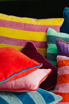 colorful pillows are stacked on top of each other