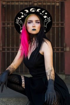 *due to printing there might be slight placement differences than pictured. A sturdy thick 100% polyester hat. I have applied moons and a cosmic theme in white. Get your witchy vibe on. It has adjuster inside. Size S/M 22.3 inch circumference  Size M/L 22.8 inch circumference and 3.25 inch brim. Has inside adjuster. Mystical Halloween Festival Costume Hats And Headpieces, Black Wide Brim Costume Hat For Cosplay, Punk Halloween Costume Hats And Headpieces, Black Top Hat For Halloween Alternative Fashion, Punk Style Halloween Costume Hats And Headpieces, Gothic Hat For Halloween, Gothic Hat For Halloween And Alternative Fashion, Mystical Halloween Costume Hats And Headpieces, Gothic Halloween Hat For Alternative Fashion