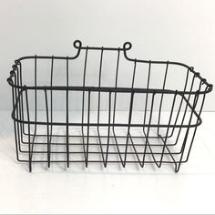 a black wire basket on a white background