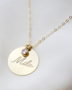 Have this custom necklace personalized with your child's name, your name, initialsor any meaningful word of your choice.This necklace is perfect for a special meaningful keepsake gift for mom, friendwife or that special someone. Gold filled or Sterling Silver Disc charm measures 19mm in diameter Cubic Zirconia measures approc. 4mm Necklace For Mom Personalized, Customized Necklace Names, Personalized Necklace Names, Personalized Jewelry For Mom, Custom Gold Jewelry, Personalized Gold Necklace, Creative Jewelry Photography, Baby Necklace, Necklace For Mom