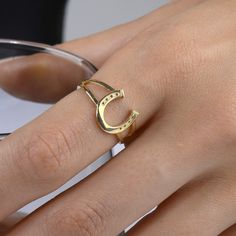 This horseshoe ring is perfect for horse lovers. It is made from solid 14ct gold and features a split shank design. It is a unique piece that celebrates western inspirations. An ideal gift for the horse lover in your life. RING DETAILS ♥ Gold Material: 14K Solid Gold ♥ Design: Minimalist split shank band with a dainty horseshoe . ♥ Gold Color Options: Choose from 14K yellow gold, 14K white gold, or 14K rose gold ♥ Craftsmanship: 100% Handmade and made to order ♥ Versatility: Perfect for daily wear or special occasions ♥ 100 % Handmade ♥ Made to Order ♥ Choose Your Ring Size: (Sizes available upon request) PROCESSING & SHIPPING We know you're excited to get your hands on your order, and we're just as excited to get it in your hands. We really care about each order and do our best to process Elegant Horseshoe Rings For Gifts, Elegant Gold Horseshoe Rings, Elegant Yellow Gold Horseshoe Rings, 14k Gold Horseshoe Ring, Equestrian Ring, Life Ring, Horseshoe Ring, Split Shank Ring, Good Luck Gifts