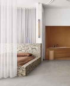 a bedroom with a bed, dresser and bathtub in the middle of the room