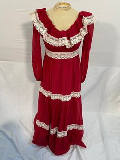 This 1970's boho style maxi is a masterpiece! Made by Union Clothing workers in the 70's, it was made in America and is in spectacular shape!  This dress is closest to a size small, but here are the exact measurements taken lying flat and doubled: Shoulders: 13 inches  Chest: 30 inches  Waist: 26 inches  Hips: 32 inches  Shoulders to Hem: 52 inches  Sweep: 42 inches   This dress has a tiered appearance to it, as it has lace details running along intermittently through the dress.  It zips up the Fall Maxi Dress With Lace Trim, Maxi Dress With Lace Trim For Fall, Lace Trim Maxi Dress For Fall, Bohemian Full-length Maxi Dress, Bohemian Full Length Maxi Dress, Vintage Prairie Dress Maxi Length, Bohemian Long Sleeve Maxi Dress With Lace Trim, Vintage Maxi Length Dress, Vintage Flowy Long Maxi Dress