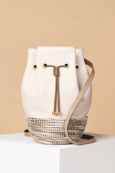 Introducing The Bucket Bag, our largest crossbody yet. The newest (limited-edition) addition to our collection features our signature sisal basket paired with luxe, heavy-weight cotton canvas &amp; fine Italian Nappa leather. The Bucket Bag combines the best of Italian craftsmanship with the skilled artistry of Rwandan