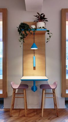 two stools and a table with plants on it