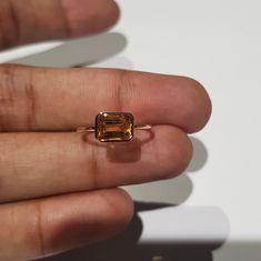 14k solid rose gold natural AAA quality emerald cut rectangular shaped citrine semi precious gemstone ring. 1. The weight of the natural citrine gemstone used in the ring =1.10 cts. 2. The weight of 14k solid rose gold used in the ring =1.130 grms. 3. The design of the ring is very nice and beautiful. 4. I have used all my skills and experience to manufacture this ring as beautiful as I can and I do hope my work will be appreciated. Thanks Rectangular Gold Emerald Ring With Bezel Setting, Rectangular 14k Gold Emerald Ring As Gift, Gold Square Cut Emerald Ring, Rectangular Prong Set Topaz Ring Fine Jewelry, Rectangular Yellow Gold Emerald Ring With Prong Setting, Gold Emerald Cut Topaz Ring, Rectangular Rose Gold Jewelry With Prong Setting, 14k Gold Rectangular Solitaire Jewelry, 14k Gold Solitaire Jewelry With Rectangular Shape