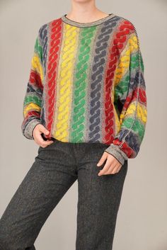 This vibrant Carlo Colucci sweater showcases the bold, colorful patterns the brand is famous for. Made from a light cotton blend, its multicolored design instantly brings a unique statement to your wardrobe. Known for their artistic knitwear, Carlo Colucci pieces are a favorite for those who love retro, eye-catching style with a premium feel. The fabric composition is not indicated, however it feels like a light-weight cotton and wool blend, possibly with some acrylic fibers as well. In excellen Retro Multicolor Knit Sweater, Vintage Multicolor Knit Sweater, Retro Multicolor Winter Sweater, Multicolor Retro Winter Sweater, Vintage Multicolor Jacquard Knit Sweater, Vintage Multicolor Sweater For Fall, Colorful Retro Crew Neck Sweater, Multicolor 90s Sweater For Winter, 90s Multicolor Sweater For Winter