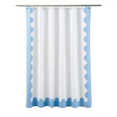 a blue and white shower curtain with scallops on the bottom, in front of a white background