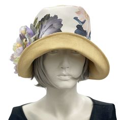 HANDMADE IN THE USAWear this lovely Eleanor cloche hat to a garden party, the horse races, or an afternoon wedding and you’ll appear just as chic as Mary on Downton Abbey in today’s 20s. Meticulously crafted with care, this wide brim linen hat - lined in soft cotton - offers effortless style without sacrificing comfort. Its full head coverage will protect you from the sun on a hot afternoon, and the pretty peony flower brooch adds a feminine touch. The flower is removable and can be worn elsewhe Fitted Cream Fedora For Spring, Wide Brim Sun Hat For Spring Garden Party, Spring Cloche Hats For Races, Spring Fedora With Short Brim For Formal Occasions, Spring Formal Fedora With Short Brim, Spring Races Wide Brim Boater Hat, Spring Boater Hat For Races, Chic Brimmed Top Hat For Spring, Spring Races Sun Hat With Short Brim