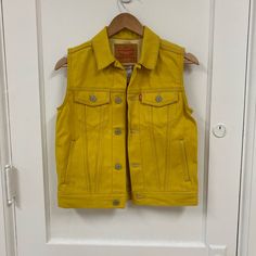 Nwt Levi’s Jean Vest. P2p 16.5” Never Worn Classic Vest With Snap Buttons For Spring, Classic Spring Vest With Snap Buttons, Yellow Sleeveless Outerwear For Fall, Sleeveless Yellow Outerwear For Fall, Yellow Sleeveless Fall Outerwear, Fitted Levi's Cotton Outerwear, Fitted Yellow Cotton Outerwear, Fitted Yellow Vest For Fall, Local Thrift Stores