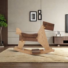 a wooden rocking horse sitting on top of a rug in front of a flat screen tv