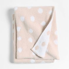 a pink blanket with white polka dots on it