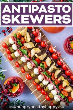 an appetizer skewers with tomatoes, olives and other vegetables