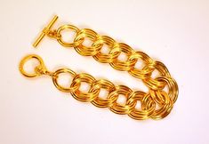 Fabulous ANNE KLEIN massive gold tone double chain link bracelet with Anne Klein Lion logo toggle. The bracelet is ...." long, ...." wide with a toggle clasp. This one weighs ... oz. It is vintage item in very good condition. We combine shipping.   Thank You for visiting our Etsy https://www.etsy.com/shop/VictoryIssweet store! Gold Oval Link Chain Bracelet With Clasp, Gold Link Chain Bracelet With Clasp, Vintage Statement Jewelry, Double Chain Bracelet, Lion Logo, Double Chain, Bracelet Vintage, Lion Head, Toggle Clasp