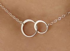 "Forever linked together, two cute tiny eternal circles form the center of this beautiful necklace. The two linked circles are in shining sterling silver and catch the light beautifully. At the center of a sterling silver chain and spring clasp, these symbols of eternity and love create a necklace of elegance, and simplicity. The sterling silver circles themselves measuring 19mm x 12mm or 1/2\" x 3/4\". ( small circle measures 10mm x 10mm or x 3/8\" x 3/8\" ; bigger circle measures 12mm x 12mm o Summer Honeymoon, Linked Rings, Double Circle Necklace, Bling Things, Interlocking Rings, Interlocking Circle Necklace, Interesting Jewelry, Bridesmaid Necklace Gift, Honeymoon Style