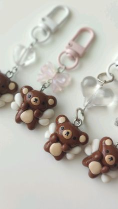 a brown teddy bear key chain with white and pink beads