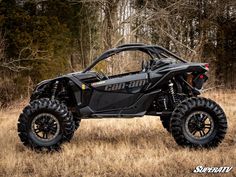 a black can - am commander is parked in the grass