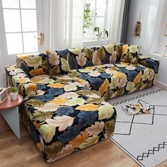 a living room scene with focus on the couch and large floral print sectional sofa cover