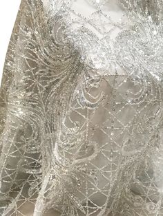 "5 YARDS / Luxurious Abstract Full Body Beaded Glitter Geometric Embroidery Mesh Lace / Dress Fabric We sell this fabric in 5 YARDS INCREMENTS 100% Polyester Width - 51/52\" Stretch: 4-way Use - Apparel, Costumes, Appliqué, Wedding/Evening gowns, Formal Wear, Dresses, Crafts ACTUAL PRODUCT COLORS MAY DIFFER FROM IMAGE ON YOUR COMPUTER DUE TO DIFFERENT MONITOR SETTINGS ORDER PROCESS: * Sold by the yard. * No exchanges or returns. PACKING YOUR ORDER: *CUT ORDER We cut and fold your fabric into a s Elegant Sequin Fabric For Festive Gala, Glamorous Silver Dress With Intricate Embroidery, Fitted Silver Embroidered Fabric For Festive Occasions, Silver Embroidered Fabric For Festive Occasions, Elegant Embellished Embroidered Fabric For Celebration, Festive Sparkling Sequin Dress For Weddings, Festive Sparkling Sequin Wedding Dress, Festive Wedding Sequin Dress, Glamorous Embroidered Sequin Fabric For Celebration