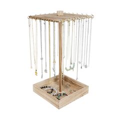 a wooden jewelry stand with several necklaces hanging from it