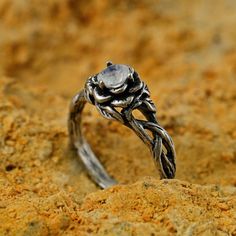 a close up of a ring on sand