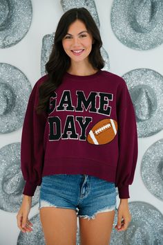 This maroon and black GAME DAY VARSITY PULLOVER is perfect for any sports fan. Made with ultra soft fabric and classic varsity letters, this pullover features a football patch for an extra touch of sporty spirit. Shop now and show off your team pride! All orders are currently shipping within 14 business days. To receive item quicker, expedited shipping is available at checkout. Black Sweatshirt For Game Day In Fall, Black Tops With Ribbed Cuffs For Game Day, Collegiate Team-colored Sweatshirt For Fall, College Team-colored Sweatshirt For Fall, Collegiate Black Sweatshirt For Football Season, Collegiate Sweatshirt For Football Season, Collegiate Sweatshirt For College Football Season, Varsity Tops For Fall Sports Events, Varsity Tops For Sports Events In Fall