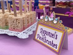 there are several desserts on the table with name plates and place cards for guests to eat