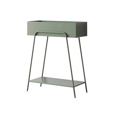 the side table is made from metal and has a shelf on one end, with a drawer