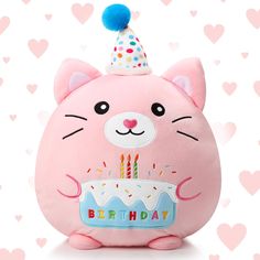 a pink stuffed animal with a birthday cake on it's face