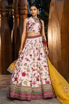 Blush pink lehenga with all-over floral printed motifs, embroidered border and cutwork hem. Paired with printed blouse. Comes with a yellow embroidered dupatta.
Component: 3
Pattern: Printed, Embroidered
Type Of Work: Floral motifs
Neckline: Round neck
Sleeve Type: Sleeveless
Fabric: Blouse and lehenga skirt: Natural silk, Dupatta: Soft net
Color: Pink
Other Details: 
Back zipper
Printed motifs
Cutwork hem lehenga
Note: The necklace, bag shown, blue lehenga set and outfit worn by the other male Mehandi Outfits, Sangeet Outfit, Blue Lehenga, Pink Lehenga, Lehenga Skirt, Natural Silk, Blouse Length, Bridal Set, Floral Motifs