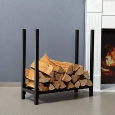 a stack of firewood in front of a fireplace