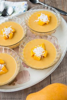 four desserts are arranged on a white platter