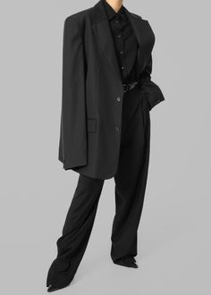 Color: Black
 Midweight traditional suiting fabric 
 Oversized tailored silhouette Padded shoulders
 Button front closure Flap front pockets Lined 65% Lyocell 25% Rayon 10% Wool
 Dry Clean By The Frankie Shop. Imported Classic Black Pantsuit For Office, Black Single Breasted Pantsuit For Fall, Classic Black Pantsuit With Pockets, Black Single Breasted Pantsuit For Business Casual, Black Single-breasted Pantsuit For Business Casual, Black Single Breasted Suit For Work, Black Outerwear With Concealed Placket For Office, Black Suit With Concealed Placket For Work, Black Business Pantsuit With Welt Pockets