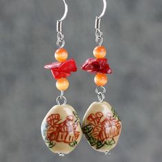 "The crocheted wiring necklace is handmade using hand painted ceramic, red coral, cat eye; with Sterling silver hook. A unique color palette of coral, peach and golden brown. Coral is vibrant and punchy, peach is soft and feminine, gold is luxury and elegant. The meaning of the Chinese writing on the ceramic is \"The flower is blossoming, the fortune is coming\". Who can resist this temptation? The length of the necklace is 17-19 inches, 43-48cm. The length is well suited to crew and high neckli Handmade Orange Resin Necklace, Handmade Vintage Resin Jewelry, Red Hand-painted Dangle Jewelry, Red Hand Painted Dangle Jewelry, Coral Dangle Jewelry For Gifts, Hand Painted Red Dangle Jewelry, Adjustable Hand-painted Red Jewelry, Adjustable Red Hand-painted Jewelry, Adjustable Hand Painted Red Jewelry