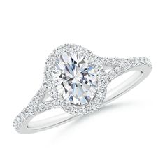 a white gold ring with an oval cut diamond surrounded by pave set round diamonds