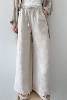 The Island Time Wide Leg Linen Pants in Natural are a dream pair of summer pants! The natural fabric and lightweight feel make them ready for your next summer vacation! Featuring an elastic waistband, linen fabric, wide legs, pocket, natural color, oversized fit and a lightweight feel. Style these linen pants with an effortless tank top and sandals! Details & Sizing Elastic waistband Linen fabric Wide leg Pockets Natural color Oversized fit Lightweight feel Gabriella is wearing a size S Fabric 1 Straight Leg Cotton Pants, Linen Summer Pants, Cream Linen Pants, Oversized Shirt Outfit, Midi Jumpsuit, Linen Pants Outfit, Short Coats, Short Coats Women, Linen Bottoms