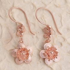 Double your fun with this gorgeous pair of flower earrings from Bali's Yuniati. Crafted from 18k rose gold plated sterling silver filigree each dangle earring features two stacked flowers with round petals in a combination finish. Rose Gold Filigree Dangle Jewelry, Rose Gold Dangle Flower Earrings In Sterling Silver, Rose Gold Dangle Earrings With Flower Charm, Rose Gold Dangle Flower Earrings, Rose Gold Flower-shaped Jewelry With Matching Earrings, Rose Gold Sterling Silver Dangle Flower Earrings, Dainty Pierced Rose Gold Flower Earrings, Rose Gold Flower-shaped Pierced Earrings, Rose Gold Flower Shaped Pierced Earrings