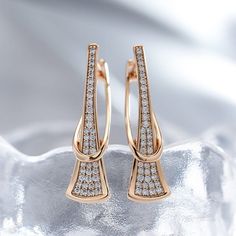 The "Isosceles" earrings features a magnificent drop design encrusted with dazzling cubic zirconia crystals throughout. Intricate curved construction and glimmering shine ensure that you are always the center of attention wherever you go. Accentuate your beauty. This is not sold in stores. and there is very limited quantity. Detailed craftsmanship Cubic zirconia encrusted Rose gold finish Gorgeous drop design For Pierced ears Material: CZ crystal. copper Rose Gold Diamond Crystal Earrings, Cubic Zirconia Drop Earrings With Plating, Cubic Zirconia Drop Earrings With Elegant Design, Elegant Cubic Zirconia Hoop Earrings With Sparkling Stones, Modern Cubic Zirconia Earrings With Plating, Elegant Sparkling Cubic Zirconia Hoop Earrings, Crystal Drop Earrings With Diamond Accents, Plated Diamond Earrings, Diamond Earrings With Plating