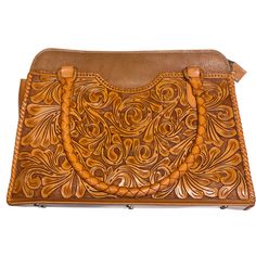 Hand Tooled Leather Large Tote Luxury Hand Tooled Brown Satchel, Luxury Hand-tooled Brown Satchel, Luxury Brown Hand-tooled Satchel, Luxury Brown Hand Tooled Satchel, Brown Engraved Leather Shoulder Bag, Leather Embossed Tote Satchel, Brown Leather Engraved Shoulder Bag, Leather Embossed Satchel Tote, Luxury Hand-tooled Satchel For Travel