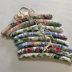 a bunch of different types of umbrellas on a white table cloth covered with fabric