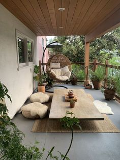 an outdoor living area with furniture and plants