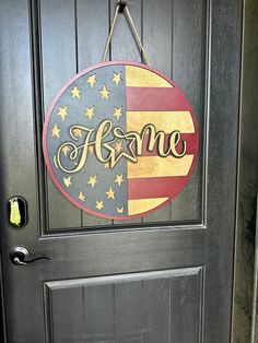 an american flag door hanger with the word home painted on it's side