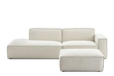 a white couch and ottoman sitting next to each other