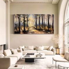 a living room filled with furniture and a painting on the wall