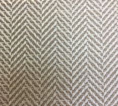 an upholstered fabric with white and grey herringbones on the back ground