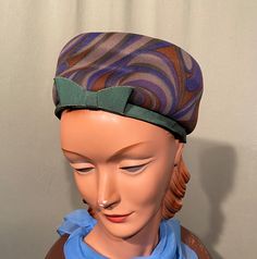 "This is a sweet vintage tall pillbox style hat that dates from the early 60s. No brand labels, only a Union label. It measures 21\"around the inside & is 3-1/2\" tall. Made of forest green, purple & brown fabric. The bottom edge is green grosgrain ribbon as is the flat bow trim. The hat is in good, vintage condition. No soil & minimal wear. Nice!" Vintage Green Mini Hat With Short Brim, Green Vintage Mini Hat With Short Brim, Retro Fitted Cloche Hat, Vintage Green Adjustable Mini Hats, Formal Vintage Green Hat, Retro Mini Hats With Curved Brim For Vintage Events, Retro Mini Hats With Short Brim For Vintage Events, Retro Mini Hats With Short Brim For Church, Retro Cloche Mini Hat For Formal Occasions