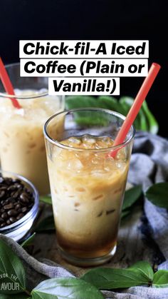 two glasses filled with iced coffee on top of a wooden table next to green leaves