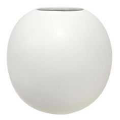 a large white vase sitting on top of a table